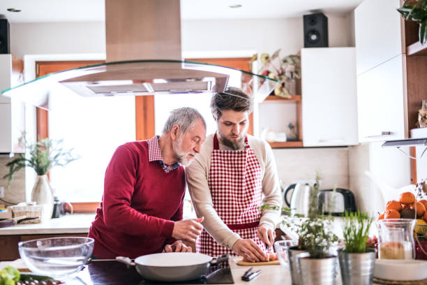 istock Hipster son with his senior father cooking in the kitchen. 912072886