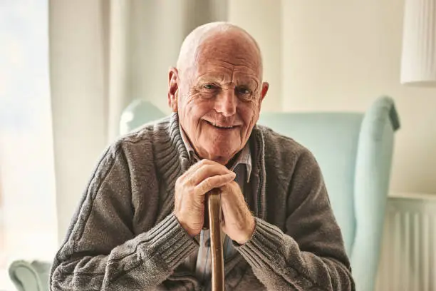 Photo of Happy senior man sitting at home