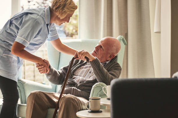 istock Female carer caring about senior man 912073348