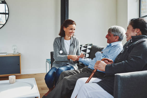 istock Female doctor visiting elderly couple 912074064