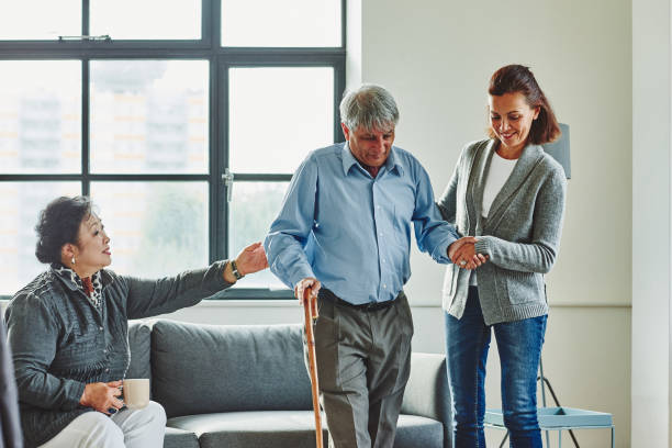istock Friendly nurse assisting senior man to walk 912074084