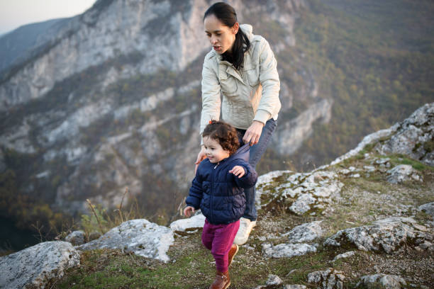 istock Mother and daughter walking on mauntain 912075062