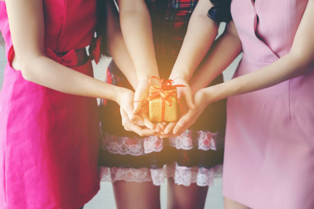 istock Midsection Of Young Women Holding Gift 912075212