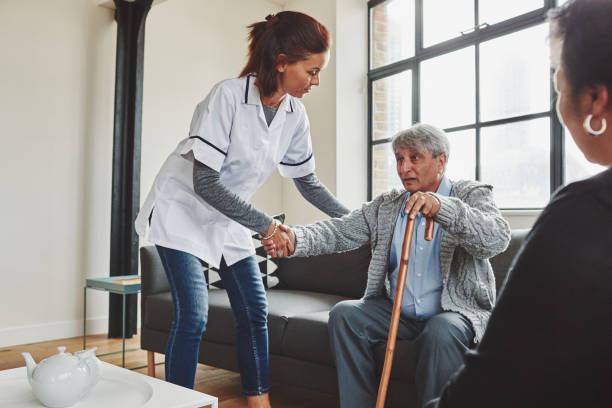istock Female nurse helping an elderly man to stand up 912081972
