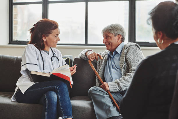 istock Carer reading book to elderly man 912082028
