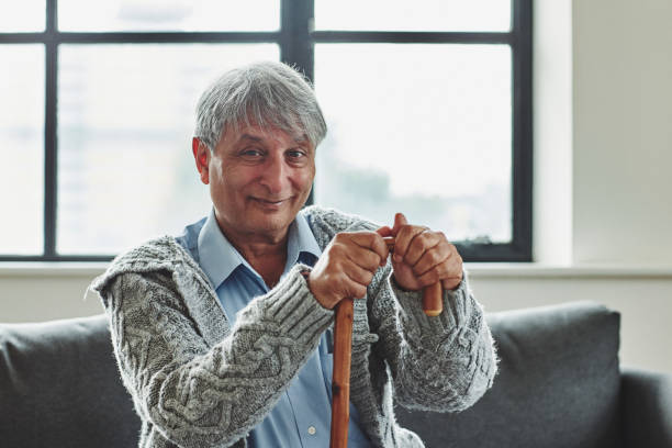 istock Happy senior man sitting with walking cane 912082034