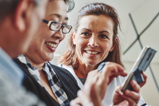 istock Carer looking at senior woman using mobile phone 912082046