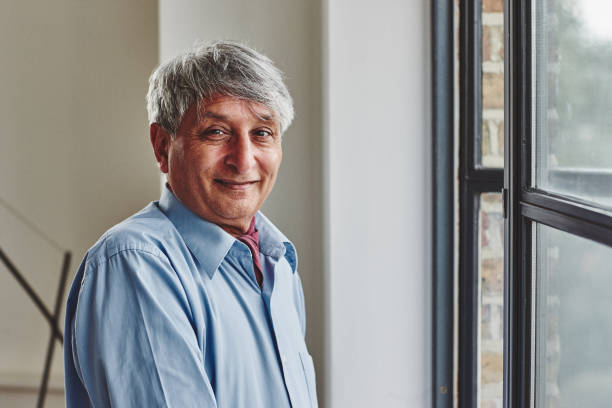 istock Happy senior man standing at home 912082154