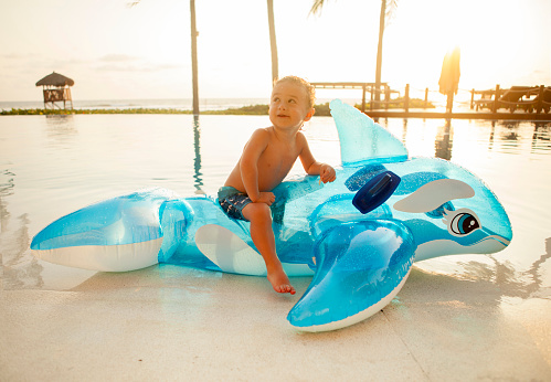 Boy with whale in a swimming pool