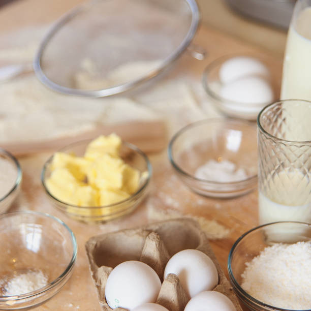istock Baking ingredients on kitchen table. White products prepare for cooking on wooden cutting board. Lifestile food concept. 912084268
