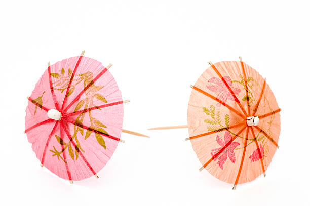 arancio e rosa partito ombrelloni - drink umbrella umbrella parasol small group of objects foto e immagini stock