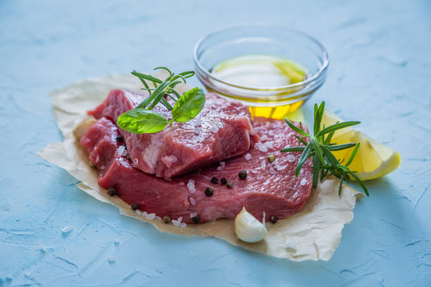 istock Raw meat with herbs, lemon, garlic, salt 912107514