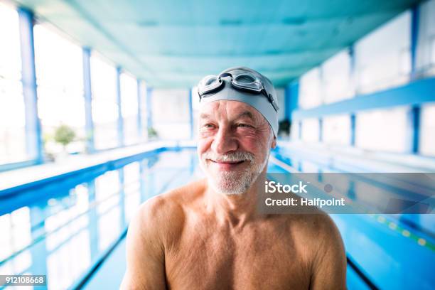 Senior Man In An Indoor Swimming Pool Stock Photo - Download Image Now - Senior Adult, Swimming, Exercising