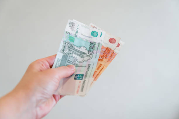 istock a woman's hand holds a five thousandth note. Russian money. 912108984