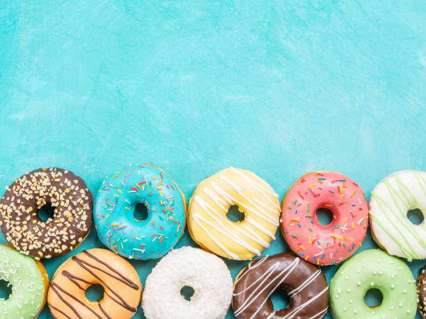 donuts on blue background , copy space, top view - sweet food sugar vibrant color multi colored imagens e fotografias de stock