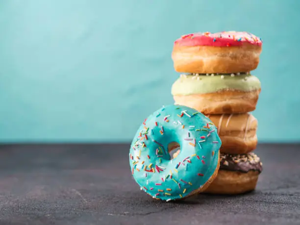 Photo of Stack of assorted donuts, copy space