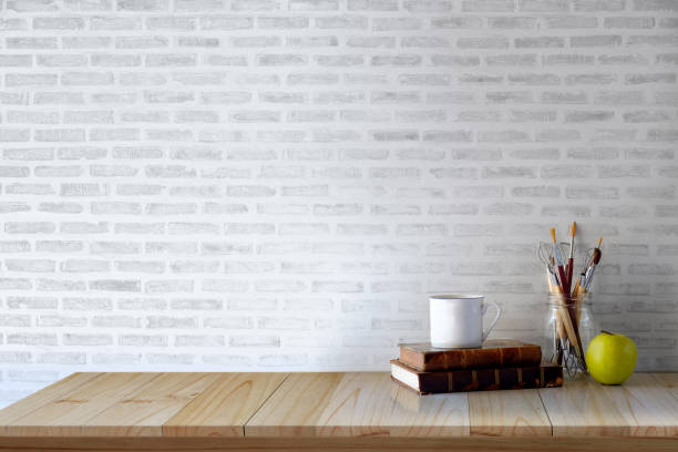 istock Workspace desk with artist tools, vintage books and coffee mug . copy space for product display montage. 912112816