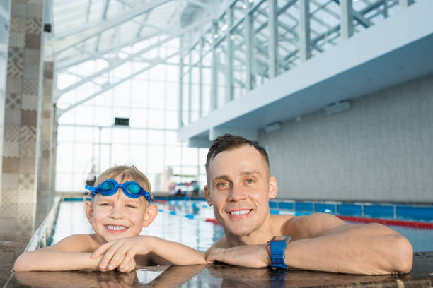 istock Little Swimmer and His Handsome Coach 912116386