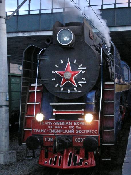 The Trans-Siberian Comes out of its Siding St Petersburg, Russia, 12th June 2004.  The famous Trans-Siberian Express, now an exclusive and elegant first class sleeper train, emerges from its siding at St Petersburg. mcdermp stock pictures, royalty-free photos & images