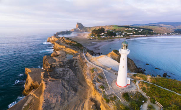 vista aerea del faro di castlepoint con villaggio castlepoint sullo sfondo. - castlepoint foto e immagini stock