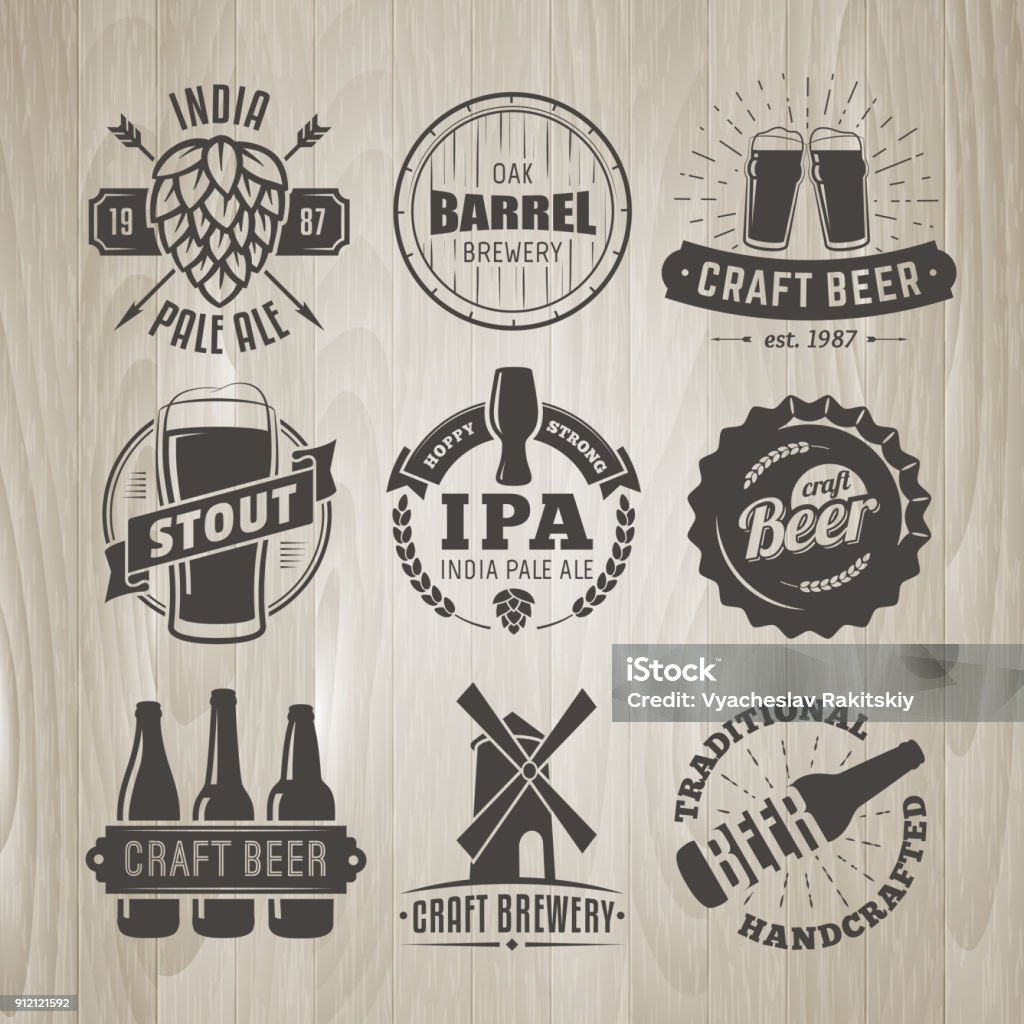 Set of vector craft beer logos and badges. Set of vector craft beer logos and badges. Retro beer labels on vintage wooden background Beer - Alcohol stock vector