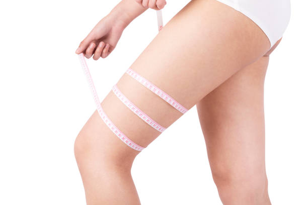 istock Young woman measuring her thigh 912125212