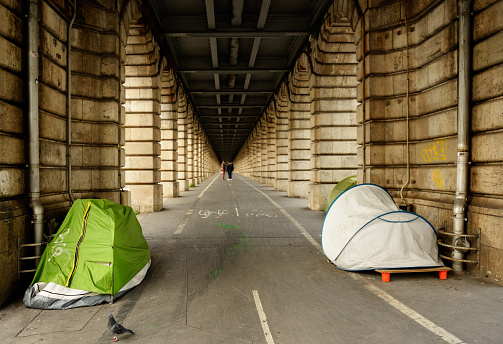 Tents of homeless people under subway viaduct in Paris