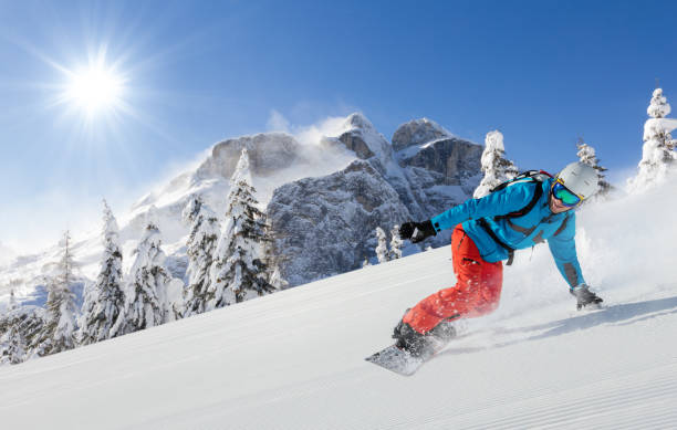 istock Young man snowboarder running downhill in Alps 912126148