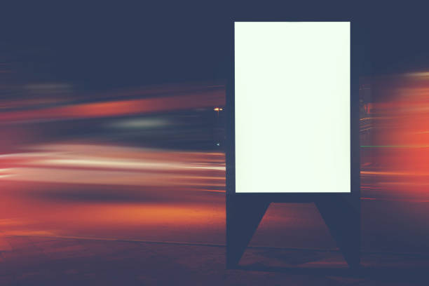 istock Illuminated blank billboard with copy space for your text message or content, public information board with shutter speed on background, advertising mock up in urban setting, empty poster on roadside 912126150