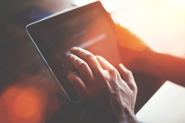 istock Cropped shot view of a man's hand touching digital tablet screen with copy space for your text message or advertising content, successful male using touch pad for remote work during recreation time 912126220
