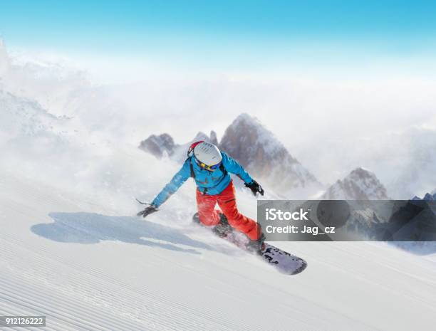 Young Man Snowboarder Running Downhill In Alps Stock Photo - Download Image Now - Snowboarding, Snowboard, Downhill Skiing