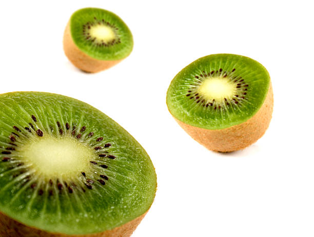 Three kiwis stock photo