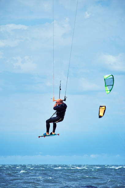 istock Man riding a kite surfing on the waves in the summer. 912129122