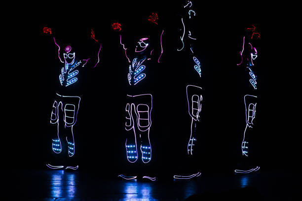 istock dancers in led suits on dark background, colored show 912129142