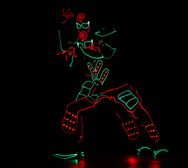 dancers crew in led suits on dark background, colored show