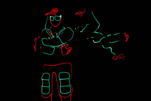 istock dancers crew in led suits on dark background, colored show 912129162