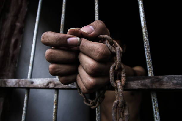 istock Prisoner holding metal cage 912129240