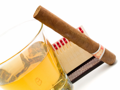 Cigar and whiskey on white