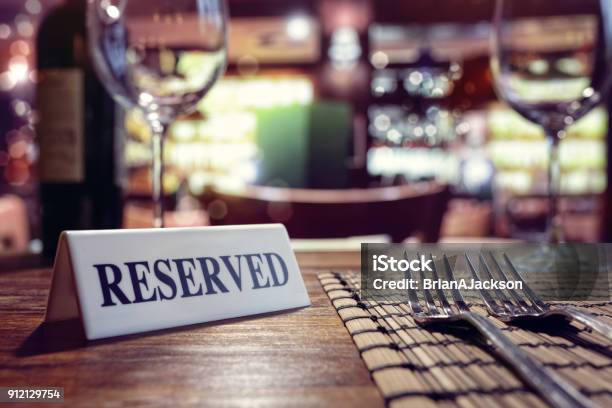 Reserved Sign On Restaurant Table With Bar Background Stock Photo - Download Image Now