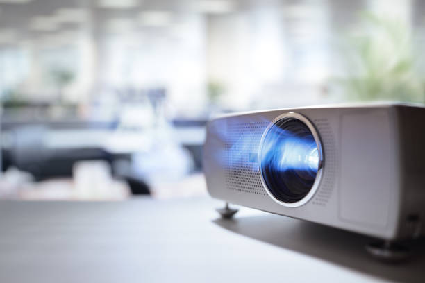 Presentation with lcd video projector in office LCD video projector at business conference or lecture in office with copy space projector screen classroom stock pictures, royalty-free photos & images