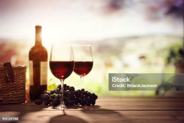 Red Wine Bottle And Glass On Table In Vineyard Tuscany Italy Stock Photo - Download Image Now