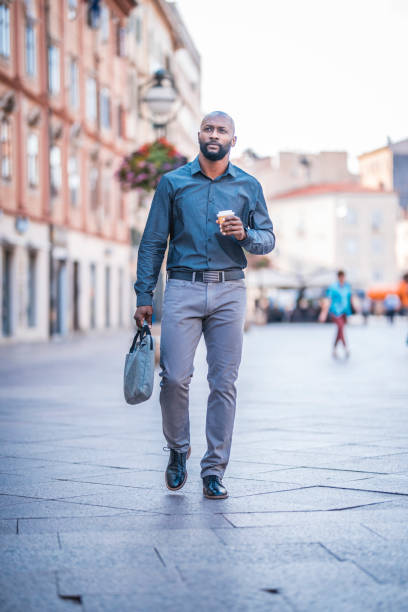 istock Business man on the go holding coffee cup 912129990