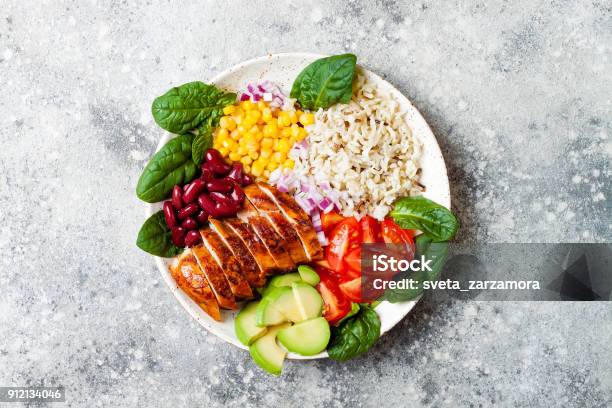 Homemade Mexican Chicken Burrito Bowl With Rice Beans Corn Tomato Avocado Spinach Taco Salad Lunch Bowl Stock Photo - Download Image Now