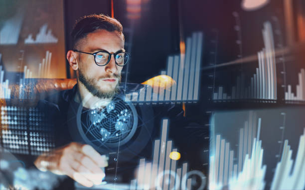istock Concept of digital diagram,graph interfaces,virtual screen,connections icon.Young businessman working at modern office.Man using contemporary laptop at night,blurred background.Horizontal. 912135148