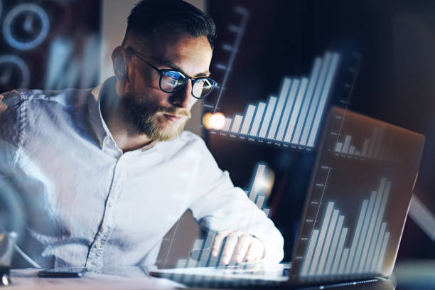 istock Concept of digital diagram,graph interfaces,virtual screen,connections icon.Young entrepreneur working at modern office on laptop.Man using digital touch pad at night,blurred background.Horizontal. 912137658