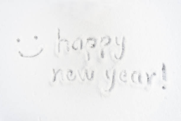 Happy new year words and smile face in snow.