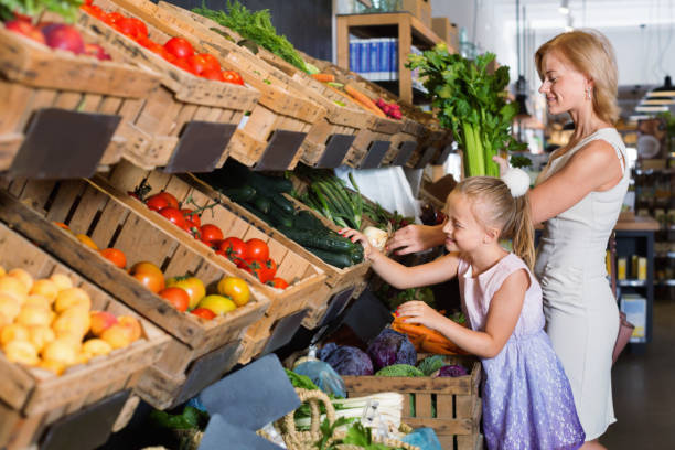 istock Glad mother with daughter shopping various veggies 912138510