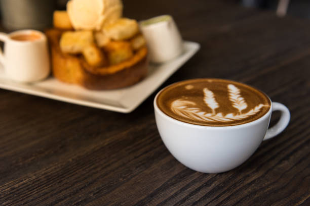istock Hot coffee latte art cup  on wooden table 912138606