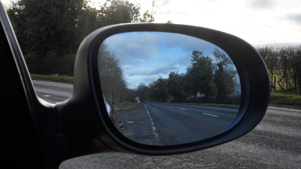 istock Country Road View from a Cars Wing Mirror 912142170