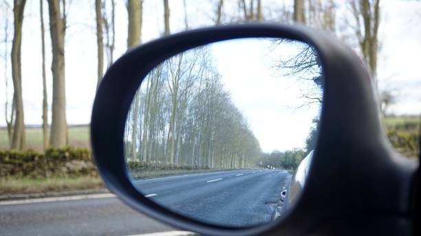 istock Country Road View from a Cars Wing Mirror 912142174